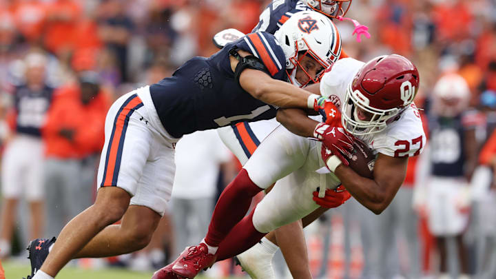 Sep 28, 2024; Auburn, Alabama, USA; Oklahoma Sooners running back Gavin Sawchuk (27) is tackled by Auburn Tigers safety Jerrin Thompson (1) during the fourth quarter at Jordan-Hare Stadium. Mandatory Credit: John Reed-Imagn Images Sep 28, 2024; Auburn, Alabama, USA; Oklahoma Sooners running back Gavin Sawchuk (27) is tackled by Auburn Tigers safety Jerrin Thompson (1) during the fourth quarter at Jordan-Hare Stadium. Mandatory Credit: John Reed-Imagn Images