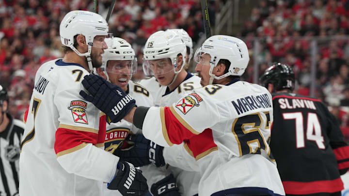 May 28, 2025; Raleigh, North Carolina, USA; (L-R) Florida Panthers defenseman Niko Mikkola (77) and defenseman Nate Schmidt (88) celebrate forward Anton Lundell (15) goal on an assist from forward Brad Marchand (63) during the second period against the Carolina Hurricanes in game five of the Eastern Conference Final of the 2025 Stanley Cup Playoffs at Lenovo Center. 