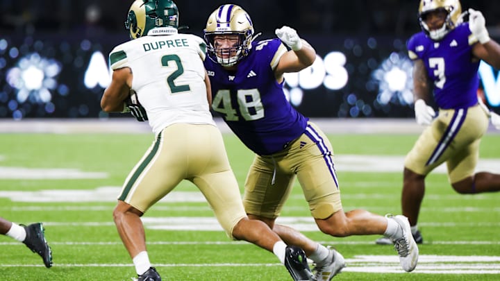 Huskies edge Jacob Lane (48) tackles Colorado running back Jalen Dupree during the fourth quarter of the opener.