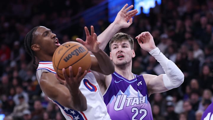 Dec 28, 2024; Salt Lake City, Utah, USA; Philadelphia 76ers guard Tyrese Maxey (0) goes to the basket against Utah Jazz forward Kyle Filipowski (22) during the second quarter at Delta Center. Mandatory Credit: Rob Gray-Imagn Images