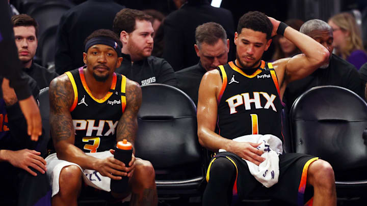 Apr 9, 2025; Phoenix, Arizona, USA; Phoenix Suns guard Bradley Beal (3) and guard Devin Booker (1) react on the bench against the Oklahoma City Thunder during the fourth quarter at Footprint Center. Mandatory Credit: Mark J. Rebilas-Imagn Images