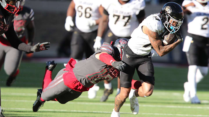 Nov 9, 2024; Lubbock, Texas, USA; Colorado Buffalos wide receiver Will Sheppard (14) is tackled by Texas Tech Red Raiders defensive back Jacob Rodriguez (10) in the first half at Jones AT&T Stadium and Cody Campbell Field. Mandatory Credit: Michael C. Johnson-Imagn Images