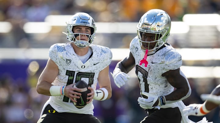 Nov 18, 2023; Tempe, Arizona, USA; Oregon Ducks quarterback Bo Nix (10) alongside running back Bucky Irving (0) against the Arizona State Sun Devils at Mountain America Stadium. Mandatory Credit: Mark J. Rebilas-Imagn Images