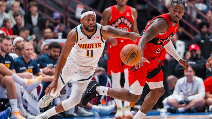 Oct 6, 2025; Vancouver, British Columbia, CAN; Denver Nuggets guard Bruce Brown (11) defends against Toronto Raptors guard Jamal Shead (23) in the second half at Rogers Arena. Mandatory Credit: Bob Frid-Imagn Images
