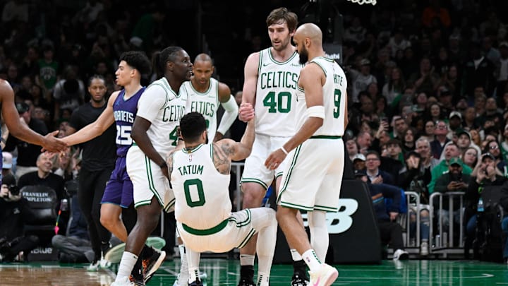 Apr 11, 2025; Boston, Massachusetts, USA; Boston Celtics guard Jrue Holiday (4) and .center Luke Kornet (40) help forward Jayson Tatum (0) to his feet during the second half against the Charlotte Hornets at TD Garden. Mandatory Credit: Eric Canha-Imagn Images