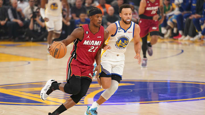 Miami Heat forward Jimmy Butler (22) dribbles past Golden State Warriors guard Stephen Curry (30) in the first quarter at the Chase Center. Mandatory Credit: Cary Edmondson-Imagn Images