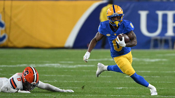 Oct 24, 2024; Pittsburgh, Pennsylvania, USA; Pittsburgh Panthers running back Desmond Reid (0) eludes Syracuse Orange defensive back Duce Chestnut (0) during the first quarter  at Acrisure Stadium. Mandatory Credit: Barry Reeger-Imagn Images
