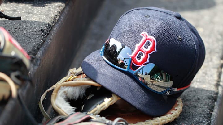 Mar 7, 2015; Sarasota, FL, USA; A general view of  Boston Red Sox hat and glove laying in the dugout at a spring training baseball game at Ed Smith Stadium. Mandatory Credit: Kim Klement-Imagn Images