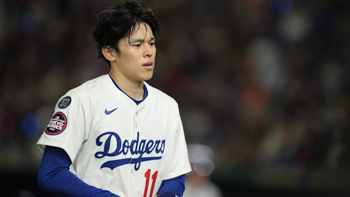 Mar 19, 2025; Bunkyo, Tokyo, JPN; Los Angeles Dodgers starting pitcher Roki Sasaki (11) walks back to the dugout in the first inning against the Chicago Cubs during the Tokyo Series at Tokyo Dome. Mandatory Credit: Darren Yamashita-Imagn Images