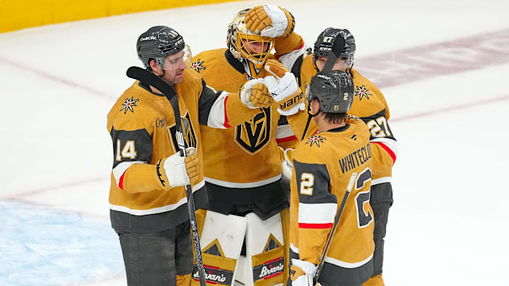 Apr 20, 2025; Las Vegas, Nevada, USA; Vegas Golden Knights goaltender Adin Hill (33) celebrates with defenseman Nicolas Hague (14), defenseman Shea Theodore (27), and defenseman Zach Whitecloud (2) after they defeated the Minnesota Wild 4-2 in game one of the first round of the 2025 Stanley Cup Playoffs at T-Mobile Arena. Mandatory Credit: Stephen R. Sylvanie-Imagn Images