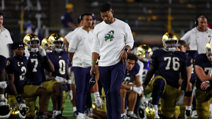 Sep 13, 2025; South Bend, Indiana, USA; Notre Dame Fighting Irish head coach Marcus Freeman looks on as the team takes a knee for Notre Dame Fighting Irish tight end Eli Raridon (9) after an apparent injury against Texas A&M Aggies during the second half at Notre Dame Stadium. Mandatory Credit: Trevor Ruszkowski-Imagn Images