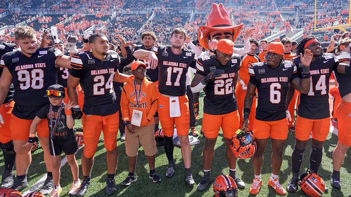OSU players sing on the field after a victory over UCF.