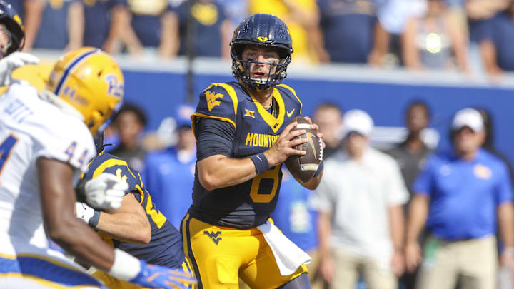Sep 13, 2025; Morgantown, West Virginia, USA; West Virginia Mountaineers quarterback Nicco Marchiol (8) drops back to pass during the first quarter against the Pittsburgh Panthers at Milan Puskar Stadium. Mandatory Credit: Ben Queen-Imagn Images
