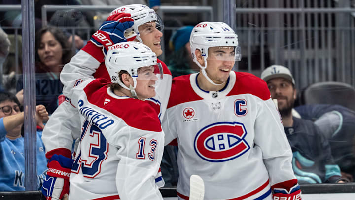 Mar 12, 2025; Seattle, Washington, USA; Montreal Canadiens forward Cole Caufield (13) forward Juraj Slafkovský (20) and forward Nick Suzuki (14) celebrate a goal during the second period against the Seattle Kraken at Climate Pledge Arena. Mandatory Credit: Stephen Brashear-Imagn Images Mar 12, 2025; Seattle, Washington, USA; Montreal Canadiens forward Cole Caufield (13) forward Juraj Slafkovský (20) and forward Nick Suzuki (14) celebrate a goal during the second period against the Seattle Kraken at Climate Pledge Arena. Mandatory Credit: Stephen Brashear-Imagn Images