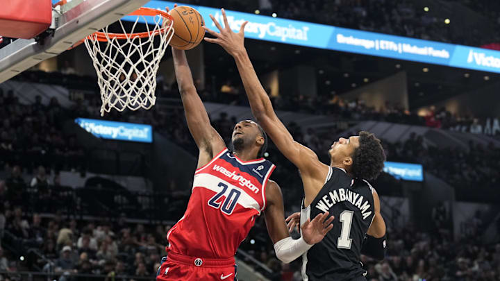 Nov 13, 2024; San Antonio, Texas, USA; Washington Wizards forward Alex Sarr (20) goes up to dunk while defended by San Antonio Spurs center Victor Wembanyama (1) during the second half at Frost Bank Center. Mandatory Credit: Scott Wachter-Imagn Images