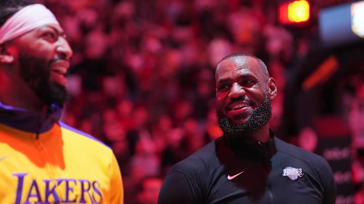 Dec 4, 2024; Miami, Florida, USA; Los Angeles Lakers forward LeBron James, right, and center Anthony Davis during pregame ceremonies before a game against the Miami Heat at Kaseya Center. Mandatory Credit: Jim Rassol-Imagn Images Dec 4, 2024; Miami, Florida, USA; Los Angeles Lakers forward LeBron James, right, and center Anthony Davis during pregame ceremonies before a game against the Miami Heat at Kaseya Center. Mandatory Credit: Jim Rassol-Imagn Images
