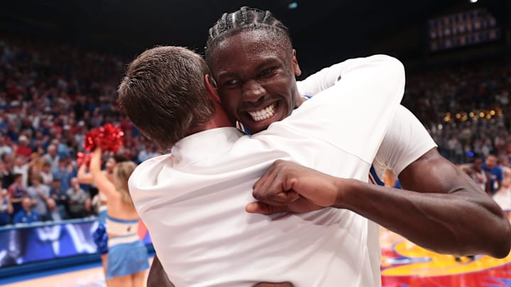 Kansas Jayhawks forward Flory Bidunga (40) hugs Kansas Jayhawks head coach Bill Self after defeating Arizona Wildcats in the game inside Allen Fieldhouse on Feb. 9, 2026.