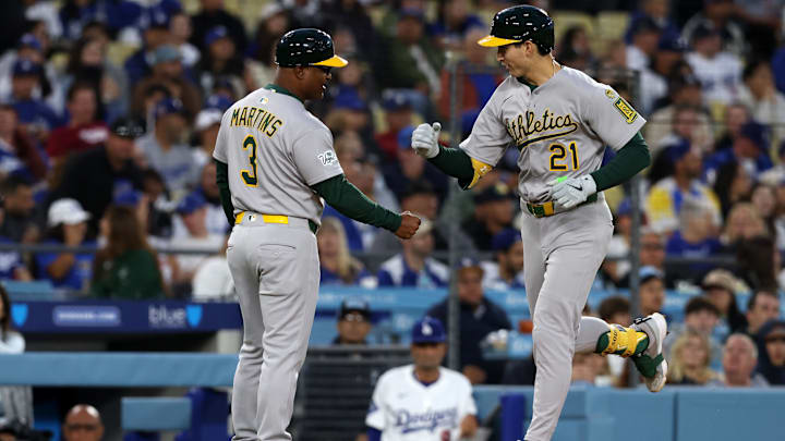 May 14, 2025; Los Angeles, California, USA; Athletics first base Tyler Soderstrom (21) reacts with third base coach Eric Martins (3) after hitting a home run during the third inning at Dodger Stadium. Mandatory Credit: Jason Parkhurst-Imagn Images