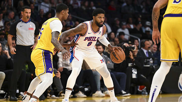 Nov 8, 2024; Los Angeles, California, USA; Philadelphia 76ers forward Paul George (8) dribbles against Los Angeles Lakers forward Cam Reddish (5) during the first half at Crypto.com Arena. Mandatory Credit: Jonathan Hui-Imagn Images