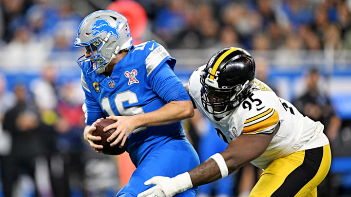 Dec 21, 2025; Detroit, Michigan, USA; Detroit Lions quarterback Jared Goff (16) runs the ball against Pittsburgh Steelers defensive tackle Keeanu Benton (95) during the first quarter at Ford Field. Mandatory Credit: Lon Horwedel-Imagn Images