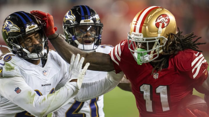 Dec 25, 2023; Santa Clara, California, USA; San Francisco 49ers wide receiver Brandon Aiyuk (11) rushes for the first down against Baltimore Ravens safety Geno Stone (26) during the fourth quarter at Levi's Stadium. Mandatory Credit: Neville E. Guard-USA TODAY Sports