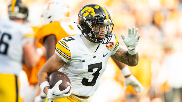 Jan 1, 2024; Orlando, FL, USA; Iowa Hawkeyes wide receiver Kaleb Brown (3) runs the ball against the Tennessee Volunteers in the fourth quarter at Camping World Stadium.