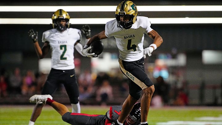 Basha wide receiver Kash Brock (4) breaks a tackle against Williams Field defensive back Bryson Raspberry (7) on his way to a touchdown during a game at Williams Field High School in Gilbert, on Sept. 12, 2025. Basha wide receiver Kash Brock (4) breaks a tackle against Williams Field defensive back Bryson Raspberry (7) on his way to a touchdown during a game at Williams Field High School in Gilbert, on Sept. 12, 2025.