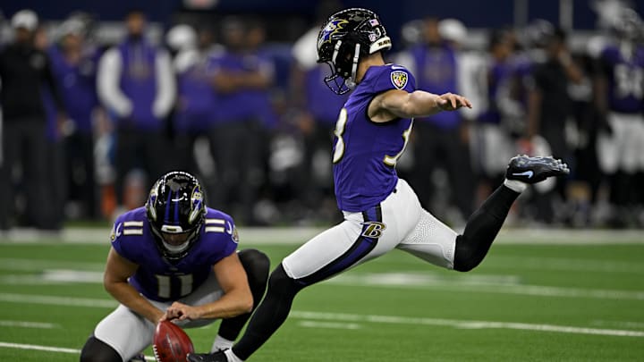 Baltimore Ravens punter Jordan Stout (11) holds the ball for place kicker Tyler Loop (33) during a field goal attempt during the game between the Dallas Cowboys and the Baltimore Ravens at AT&T Stadium. Baltimore Ravens punter Jordan Stout (11) holds the ball for place kicker Tyler Loop (33) during a field goal attempt during the game between the Dallas Cowboys and the Baltimore Ravens at AT&T Stadium.