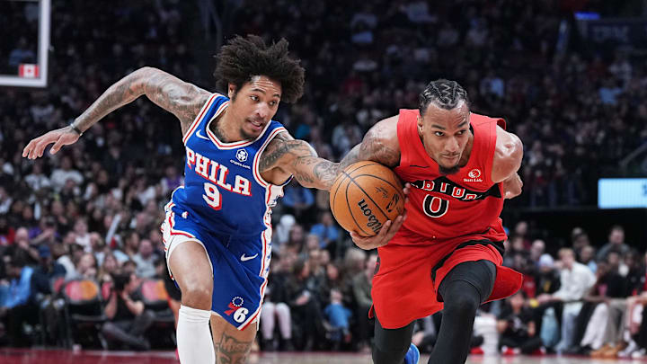 Mar 12, 2025; Toronto, Ontario, CAN; Toronto Raptors guard A.J. Lawson (0) battles for the ball with Philadelphia 76ers guard Kelly Oubre Jr. (9) during the third quarter at the Scotiabank Arena. Mandatory Credit: Nick Turchiaro-Imagn Images