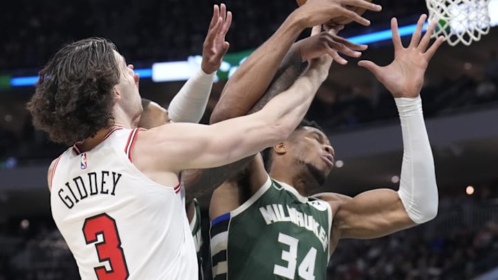 Oct 25, 2024; Milwaukee, Wisconsin, USA; Chicago Bulls guard Josh Giddey (3) and Milwaukee Bucks forward Giannis Antetokounmpo (34) battle for possession of the ball in the first half at Fiserv Forum. Mandatory Credit: Michael McLoone-Imagn Images
