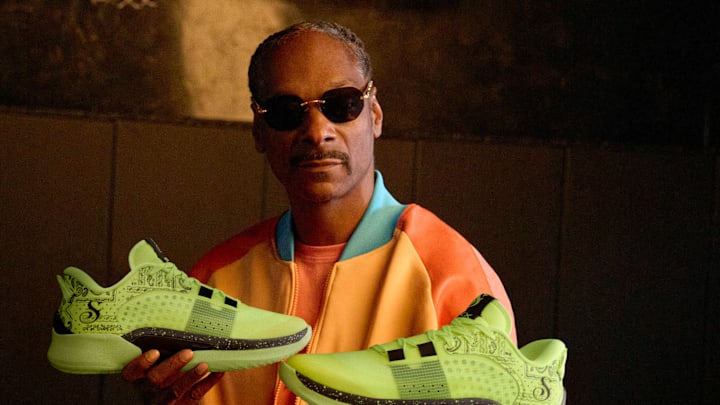 Snoop Dogg holds the Skechers x Snoop Dogg: SKX Resagrip Boss Treatment basketball shoes.