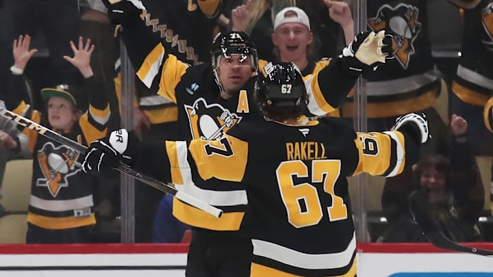 Feb 27, 2025; Pittsburgh, Pennsylvania, USA;  Pittsburgh Penguins center Evgeni Malkin (left) celebrates his game winning goal in overtime with right wing Rickard Rakell (67) against the Philadelphia Flyers at PPG Paints Arena. Mandatory Credit: Charles LeClaire-Imagn Images