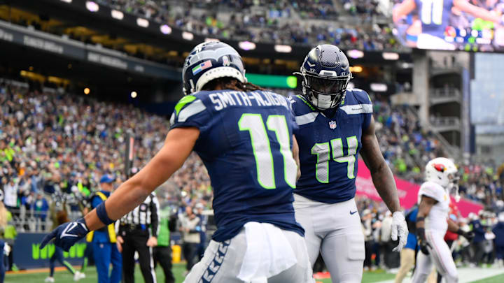 Nov 24, 2024; Seattle, Washington, USA; Seattle Seahawks wide receiver Jaxon Smith-Njigba (11) and wide receiver DK Metcalf (14) celebrate after Jaxon Smith-Njigba scored a touchdown against the Arizona Cardinals during the first half at Lumen Field. 