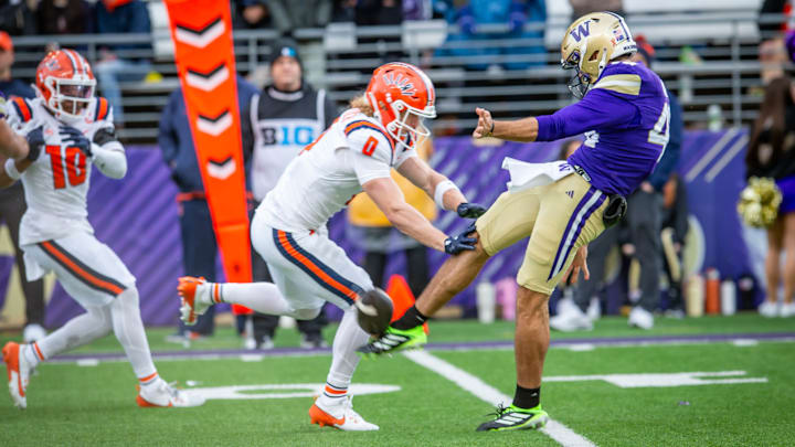 Luke Dunne gets roughed up against Illinois on a punt-block try. 
