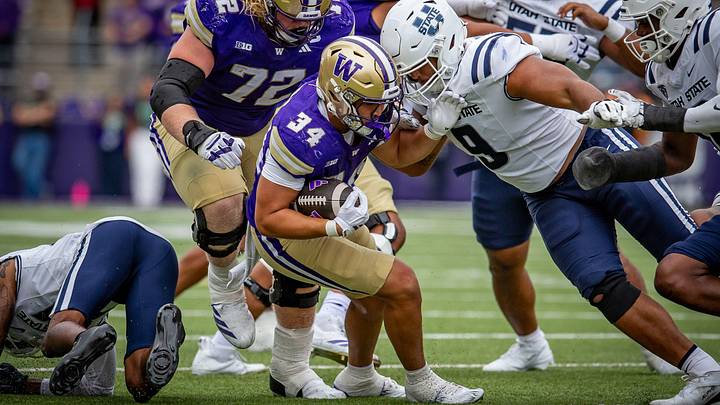 Brian Bonner Jr. picks his way through the Utah State defensive line. Brian Bonner Jr. picks his way through the Utah State defensive line.