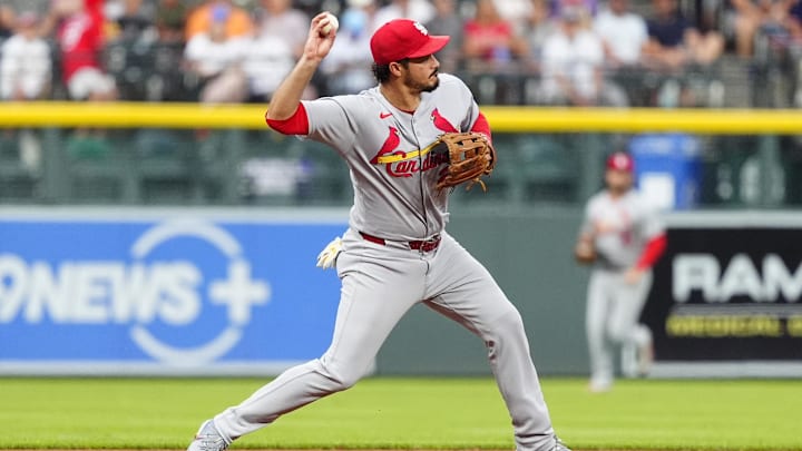Jul 22, 2025; Denver, Colorado, USA; St. Louis Cardinals third baseman Nolan Arenado (28) fields the ball in the first inning against the Colorado Rockies at Coors Field. Mandatory Credit: Ron Chenoy-Imagn Images