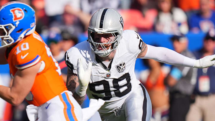 Oct 6, 2024; Denver, Colorado, USA; Las Vegas Raiders defensive end Maxx Crosby (98) chases down Denver Broncos quarterback Bo Nix (10) for a sack in the second half at Empower Field at Mile High. Mandatory Credit: Ron Chenoy-Imagn Images