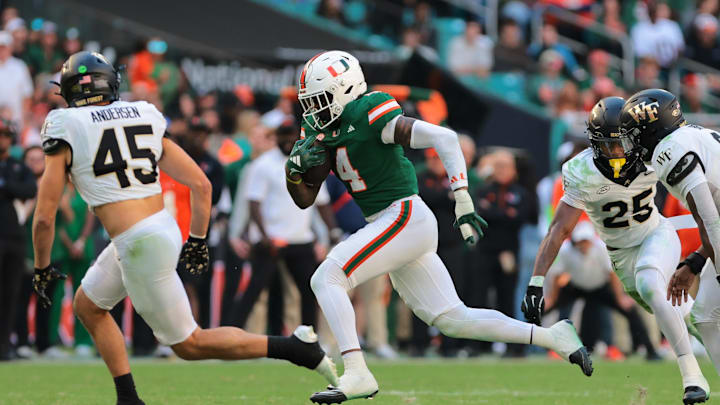 Nov 23, 2024; Miami Gardens, Florida, USA; Miami Hurricanes running back Mark Fletcher Jr. (4) runs with the football against the Wake Forest Demon Deacons during the fourth quarter at Hard Rock Stadium. Mandatory Credit: Sam Navarro-Imagn Images Nov 23, 2024; Miami Gardens, Florida, USA; Miami Hurricanes running back Mark Fletcher Jr. (4) runs with the football against the Wake Forest Demon Deacons during the fourth quarter at Hard Rock Stadium. Mandatory Credit: Sam Navarro-Imagn Images