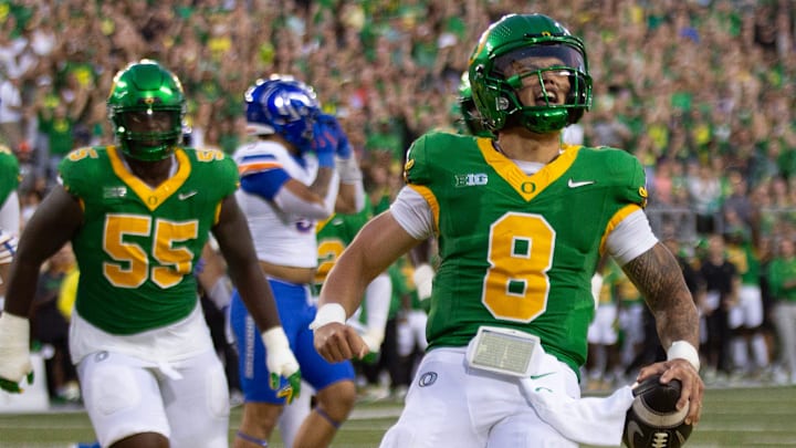 Oregon quarterback Dillon Gabriel, right, celebrates a first quarter touchdown against Boise State at Autzen Stadium in Eugene Sept. 7, 2024.