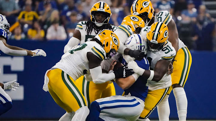 Indianapolis Colts quarterback Daniel Jones (17) is tackled by 5 Green Bay Packers on Saturday, Aug. 16, 2025, during a game against the Green Bay Packers at Lucas Oil Stadium in Indianapolis.