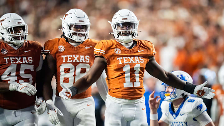 Texas Longhorns linebacker Colin Simmons (11) celebrate a quarterback sack with his teammates in the fourth quarter of the Texas Longhorns' game against the Kentucky Wildcats at Darrell K Royal Texas Memorial Stadium in Austin, Nov. 23, 2024.