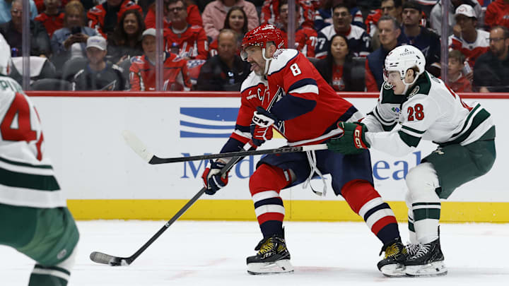 Oct 17, 2025; Washington, District of Columbia, USA; Washington Capitals left wing Alex Ovechkin (8) prepares to shoot the puck s Minnesota Wild left wing Liam Ohgren (28) defends during the first period at Capital One Arena. Mandatory Credit: Geoff Burke-Imagn Images