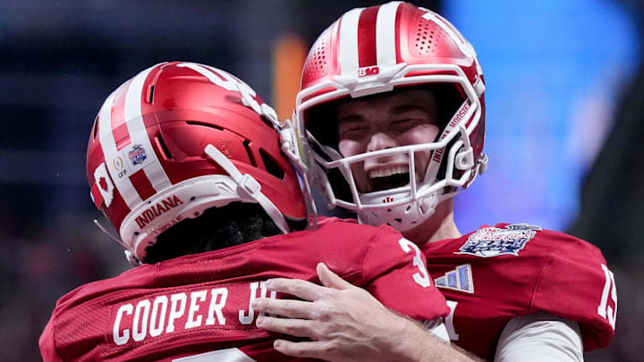 Indiana Hoosiers quarterback Fernando Mendoza celebrates with Indiana Hoosiers wide receiver Omar Cooper Jr. Indiana Hoosiers quarterback Fernando Mendoza celebrates with Indiana Hoosiers wide receiver Omar Cooper Jr.