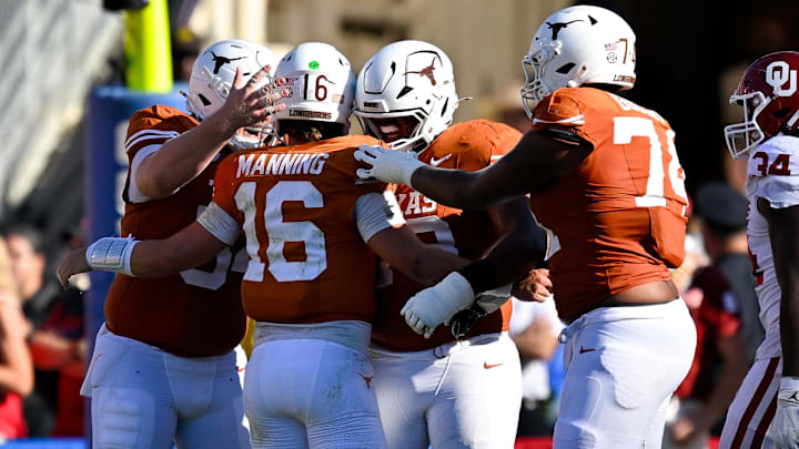 Texas Longhorns quarterback Arch Manning (16) celebrates with his lineman after he throws a touchdown against the Oklahoma Sooners during the second half at the Cotton Bowl. 