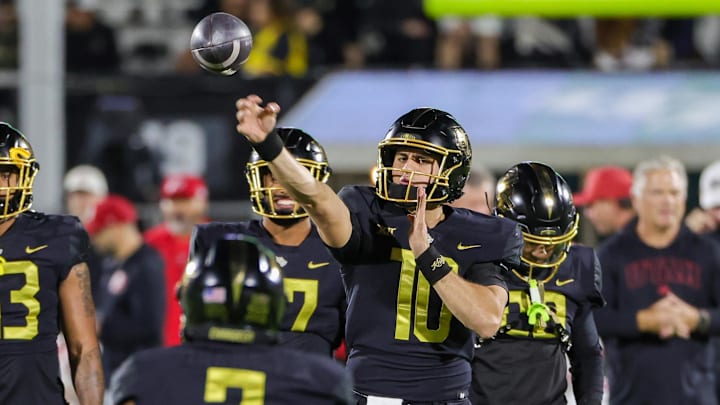 Nov 29, 2024; Orlando, Florida, USA; UCF Knights quarterback Dylan Rizk (10) warms up before the game against the Utah Utes at FBC Mortgage Stadium. Mandatory Credit: Mike Watters-Imagn Images