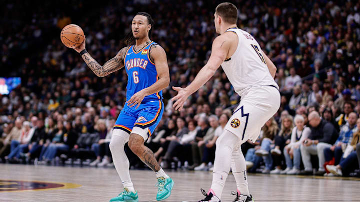 Dec 29, 2023; Denver, Colorado, USA; Oklahoma City Thunder forward Jaylin Williams (6) passes the ball as Denver Nuggets center Nikola Jokic (15) guards in the second quarter at Ball Arena. Mandatory Credit: Isaiah J. Downing-Imagn Images