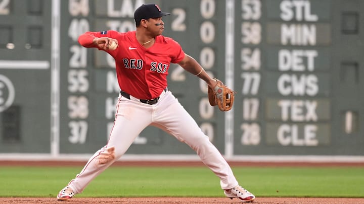 Aug 23, 2024; Boston, Massachusetts, USA; Boston Red Sox third baseman Rafael Devers (11) makes a throw for an out to end the first inning against the Arizona Diamondbacks at Fenway Park.