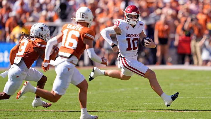 Oklahoma Sooners quarterback John Mateer (10) rushes as Texas Longhorns defensive back Jaylon Guilbeau (3) and Texas Longhorns defensive back Michael Taaffe (16) defend in the first half of the Red River Rivalry college football game between the University of Oklahoma Sooners and the Texas Longhorn at the Cotton Bowl Stadium in Dallas, Texas, Saturday, Oct. 11, 2025. Oklahoma Sooners quarterback John Mateer (10) rushes as Texas Longhorns defensive back Jaylon Guilbeau (3) and Texas Longhorns defensive back Michael Taaffe (16) defend in the first half of the Red River Rivalry college football game between the University of Oklahoma Sooners and the Texas Longhorn at the Cotton Bowl Stadium in Dallas, Texas, Saturday, Oct. 11, 2025.