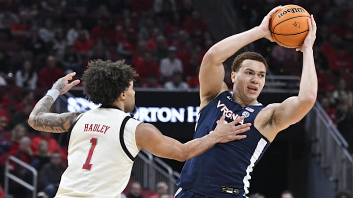Jan 18, 2025; Louisville, Kentucky, USA;  Virginia Cavaliers forward Elijah Saunders (2) looks to pass the ball under the pressure of Louisville Cardinals guard J'Vonne Hadley (1) during the first half at KFC Yum! Center. Mandatory Credit: Jamie Rhodes-Imagn Images