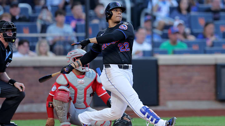 Jul 18, 2025; New York City, New York, USA; New York Mets right fielder Juan Soto (22) follows through on a solo home run against the Cincinnati Reds during the first inning at Citi Field. Mandatory Credit: Brad Penner-Imagn Images